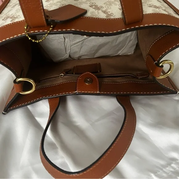 Coach Brown and Cream Tote Bag that is the sun that is casting spots on the bag - Picture 6 of 7
